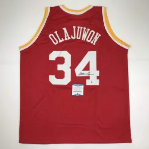 Autographed/Signed Hakeem Olajuwon Houston Red Basketball Jersey Beckett COA